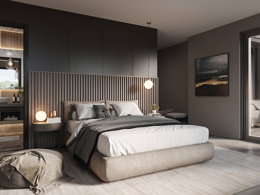 Bedroom with dark walls and a door opening into an en-suite. Lamps casting a glow onto walls and furniture.